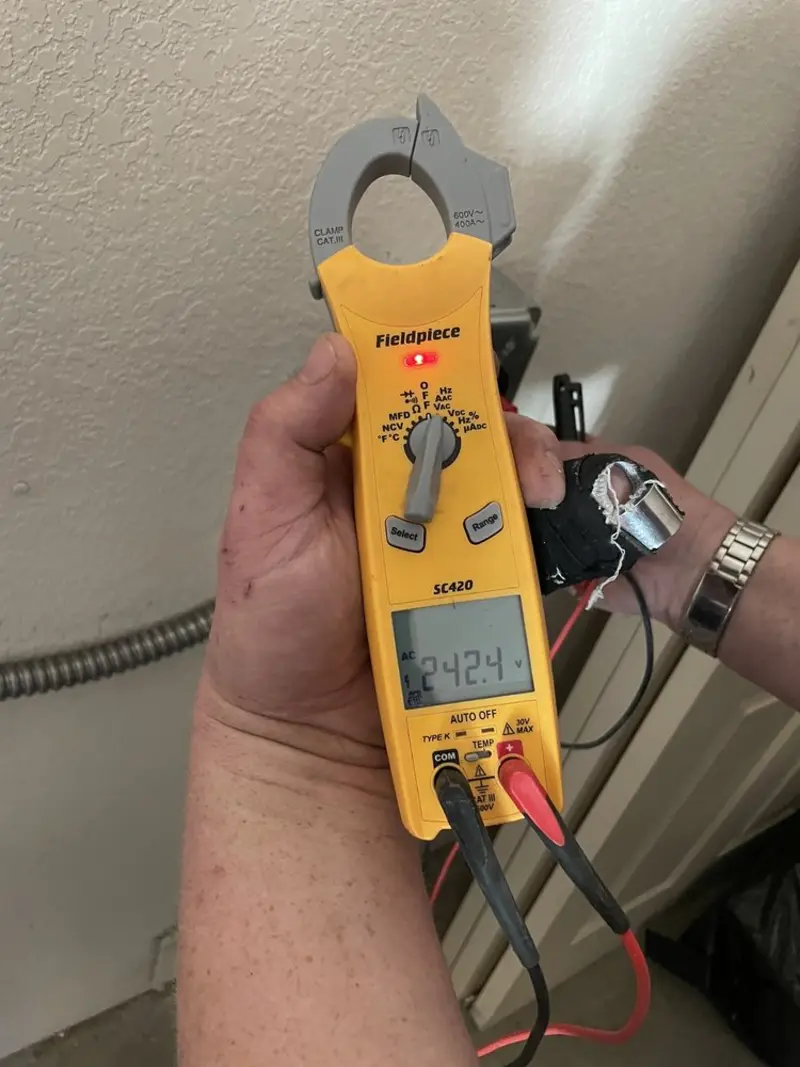 Voltage testing with clamp meter during Whole House Surge Protector in Exeter